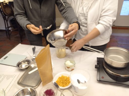 Zwei Personen bereiten Zutaten in einer Küche vor, während sie in eine Schüssel gießen.